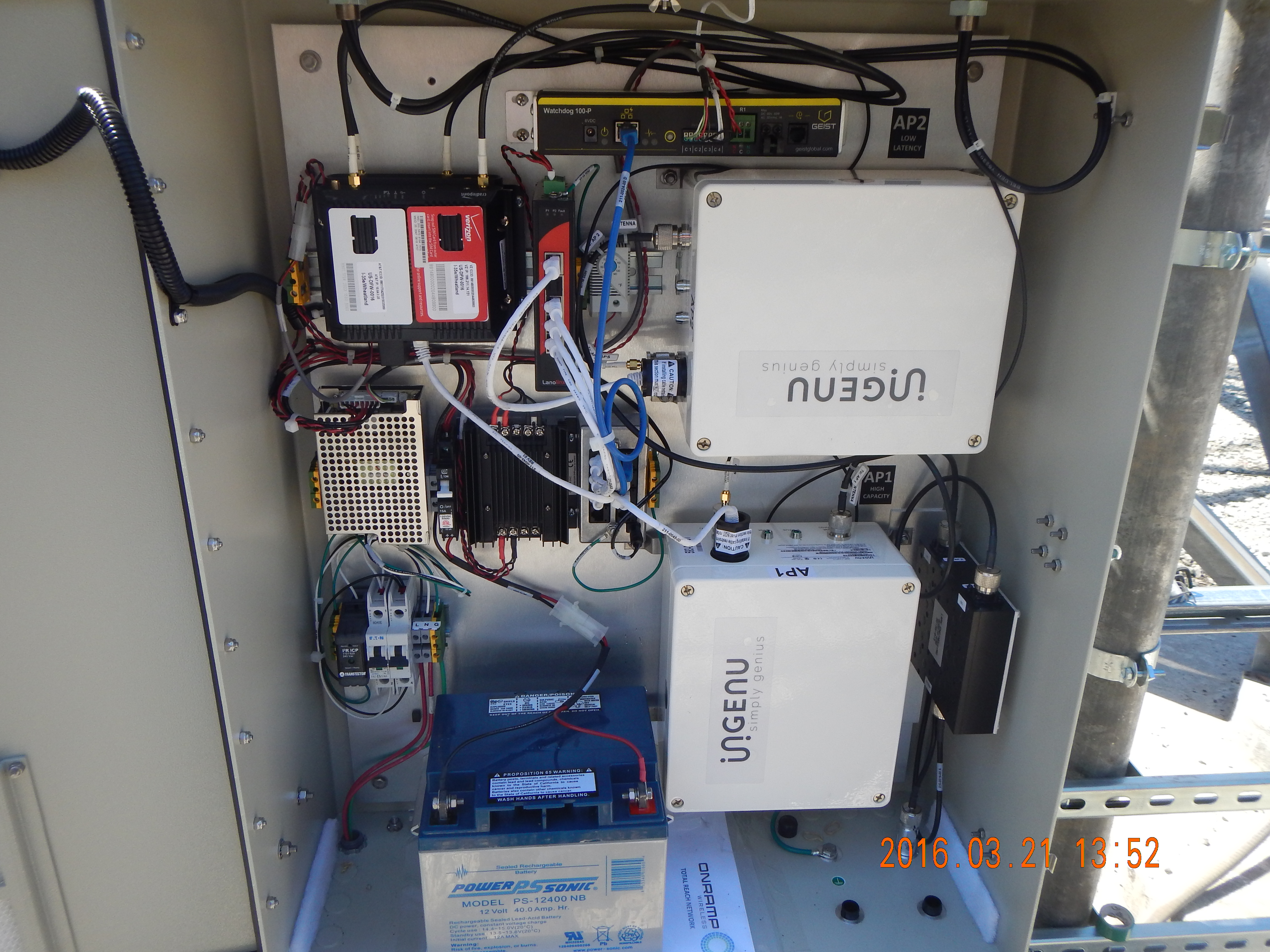 Interior view of a basestation cabinet with RPMA access points and associated networking and power equipment.