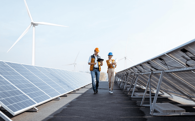 Man and woman walks through solar panels
