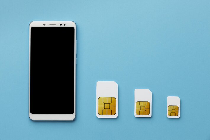 top view three sim cards with smartphone copy space