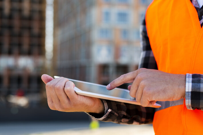 close up construction engineer using tablet